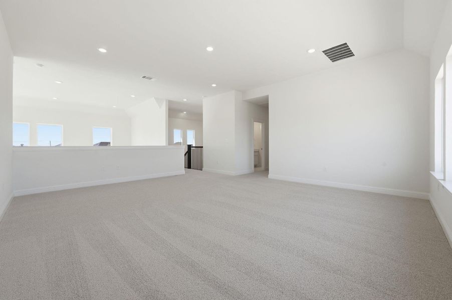Empty room featuring light colored carpet and recessed lighting