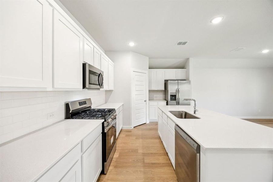 Kitchen in the Emmy II home plan by Trophy Signature Homes - REPRESENTATIVE PHOTO