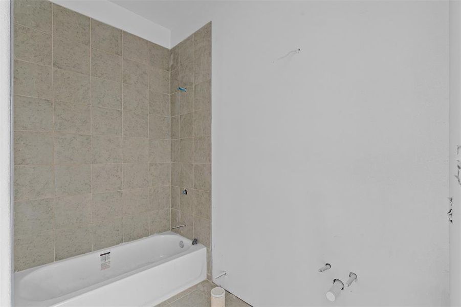 Full bathroom with shower / bath combination and tile patterned floors Full bathroom with shower / bath combination and tile patterned floors