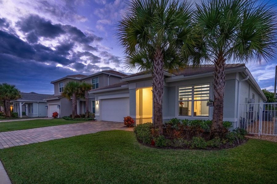 Front exterior of a new home in Windsong Estates, Lake Worth, FL, highlighting curb appeal (Image 27).