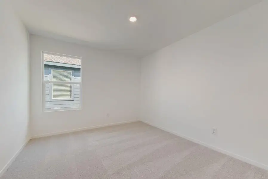 Spare room featuring light colored carpet and recessed lighting