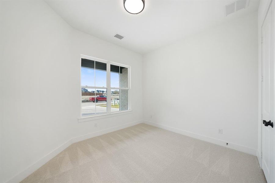 Unfurnished room with light carpet and baseboards