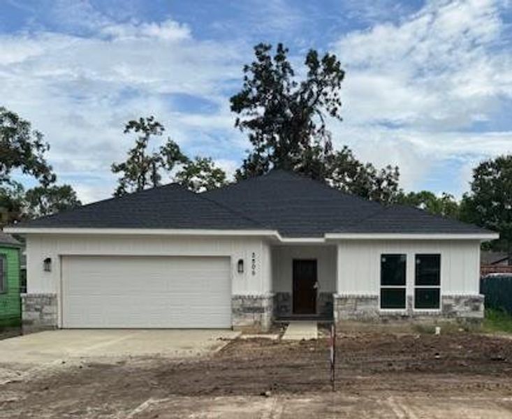 Newly constructed single-story home with a clean, modern design, featuring a two-car garage, prominent roofline, and large windows for natural light. Landscaping is yet to be completed, offering a blank canvas for the yard.