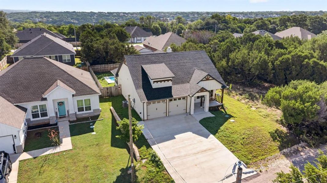 Picture of beautiful gables, designer paint colors, and oversized garage as an aerial picture.