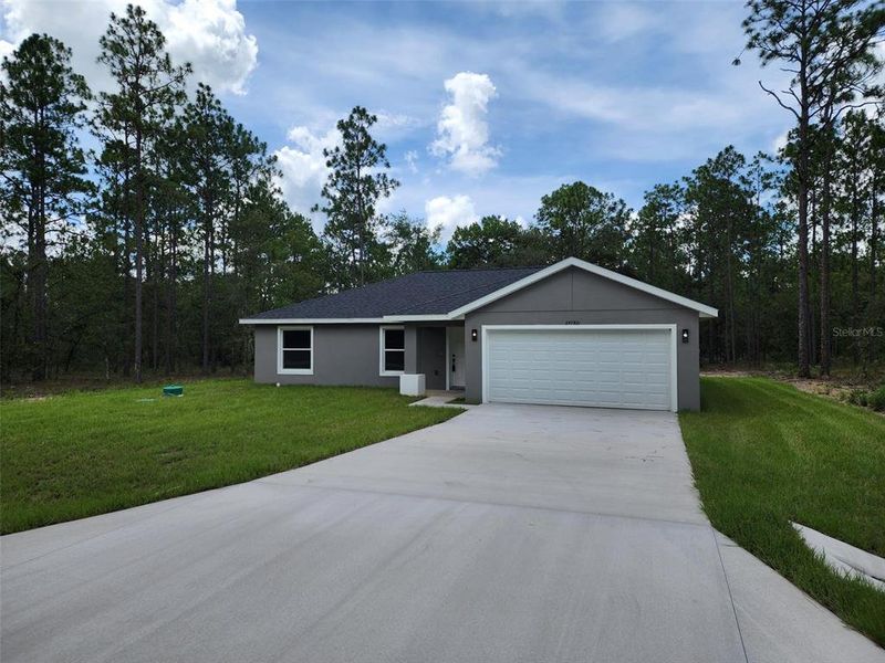 Front exterior of a new home in , Dunnellon, FL, highlighting curb appeal (Image 1).