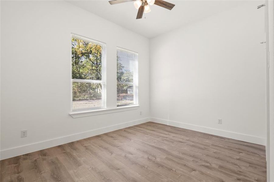 Spare room featuring ceiling fan and wood-type flooring