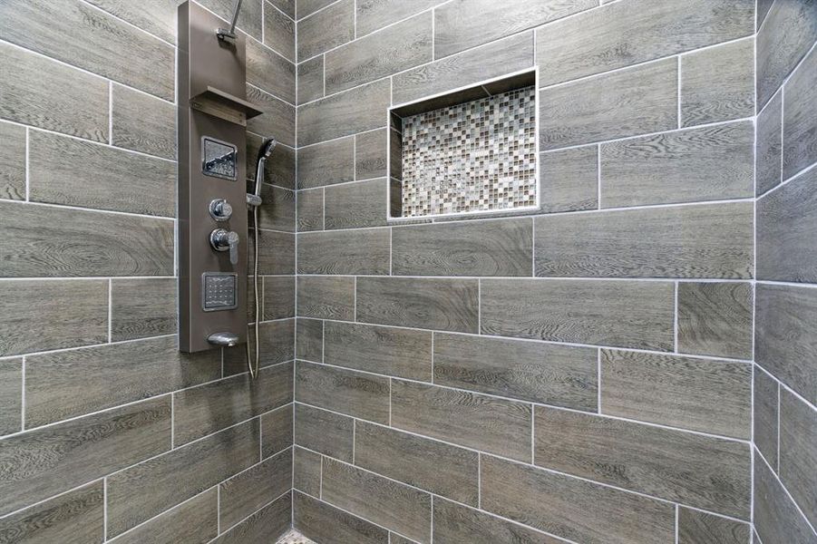 Bathroom featuring tiled shower