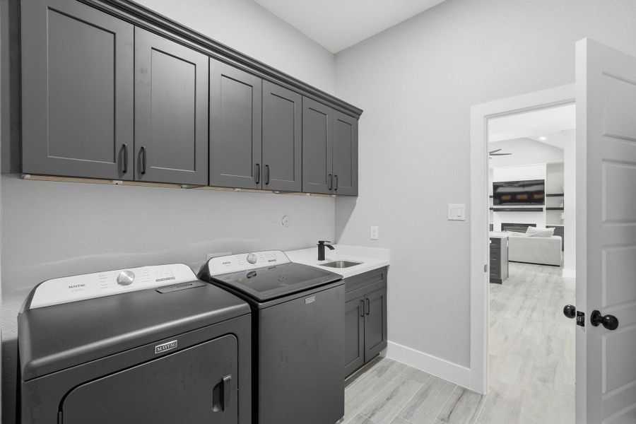 Utility room with access to the primary bedroom closet for easy access! Utility room with access to the primary bedroom closet for easy access!