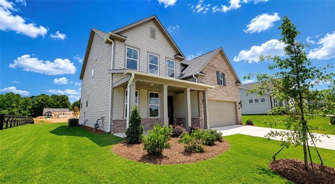 Front exterior of a new home in Wehunt Meadows, Hoschton, GA, highlighting curb appeal (Image 1). Front exterior of a new home in Wehunt Meadows, Hoschton, GA, highlighting curb appeal (Image 1).
