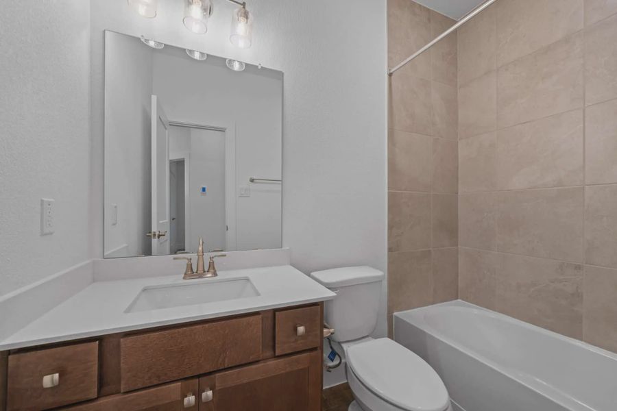 Representative furnished interior of a home built from the Carriagehouse by Chesmar Homes in Meridiana Townhomes, Iowa Colony (Image 49).