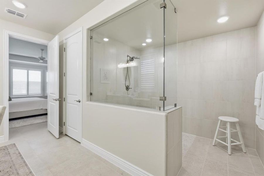 Bathroom with a walk in shower, connected bathroom, and recessed lighting