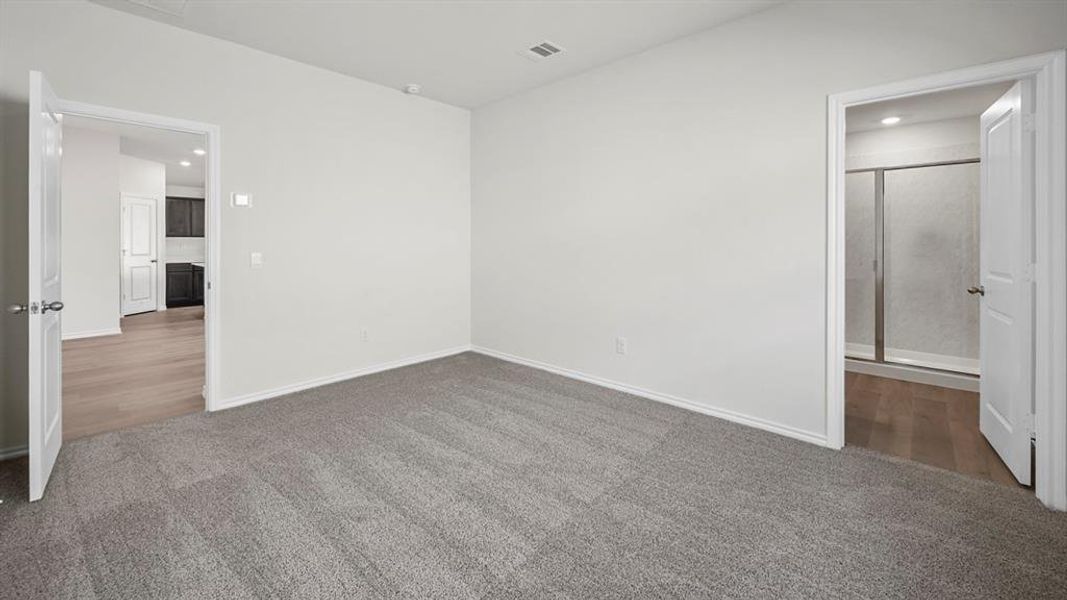 Unfurnished bedroom with recessed lighting, carpet floors, and connected bathroom