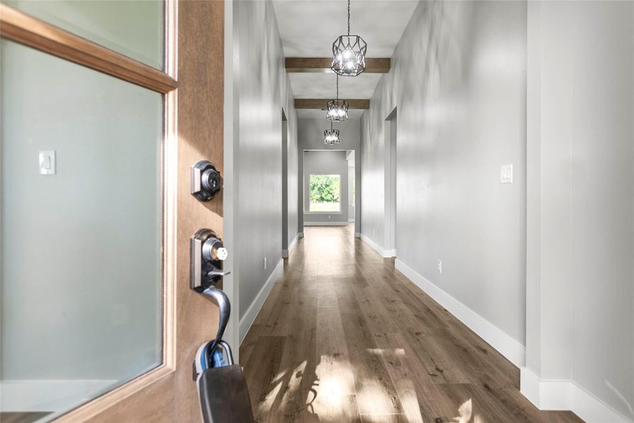 The light filled entry invites you in with warm, wood toned beams and bright pendant lighting throughout. The light filled entry invites you in with warm, wood toned beams and bright pendant lighting throughout.