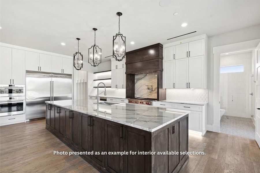 Kitchen featuring custom range hood, appliances with stainless steel finishes, a large island, wood-type flooring, and sink