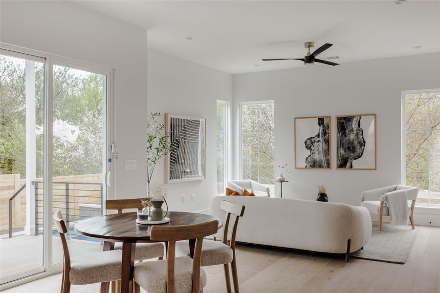 Dining area featuring ceiling fan and light wood-style floors