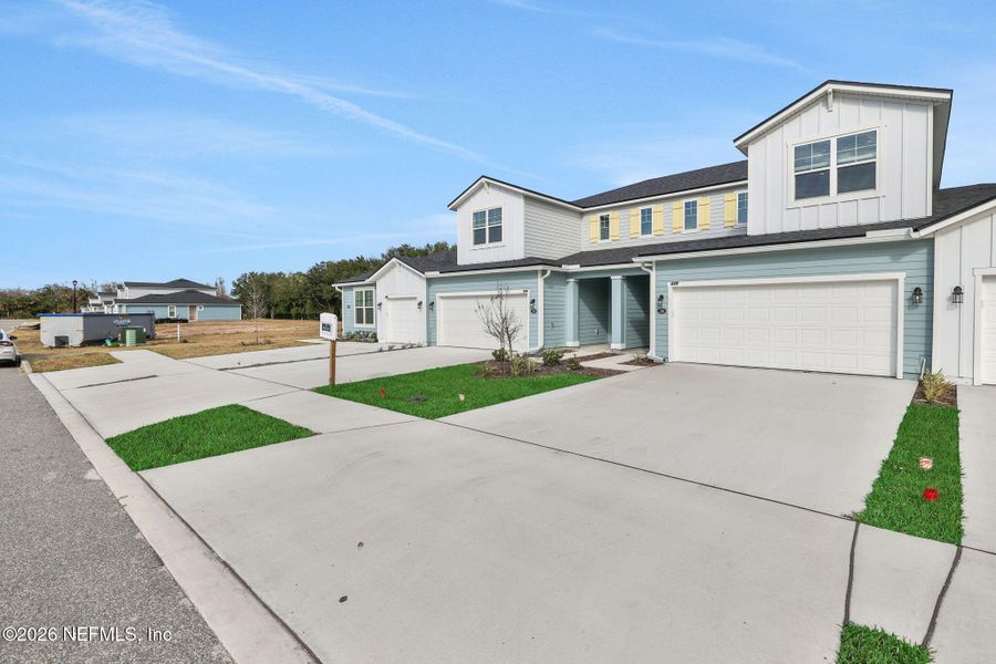 Front exterior of a new home in The Hammock at Palm Harbor, Palm Coast, FL, highlighting curb appeal (Image 19).