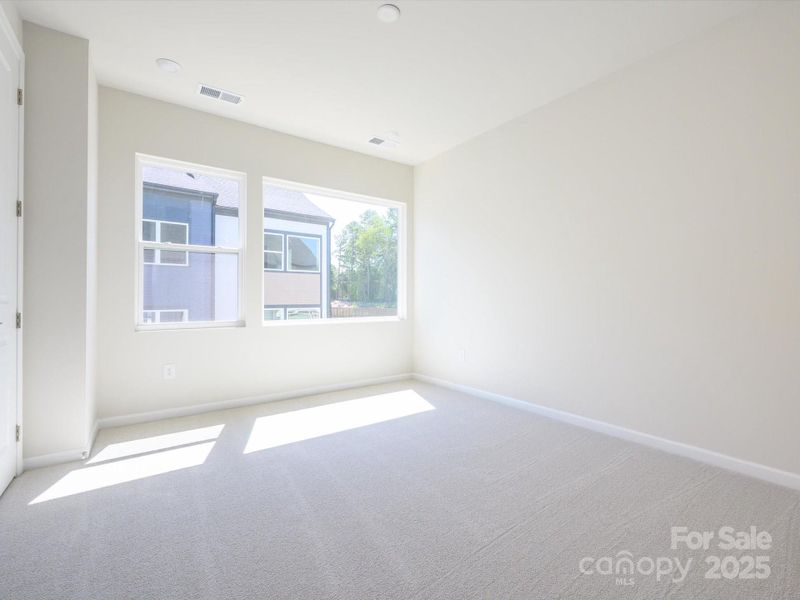 Primary suite with 9' ceilings and generously sized bright windows.