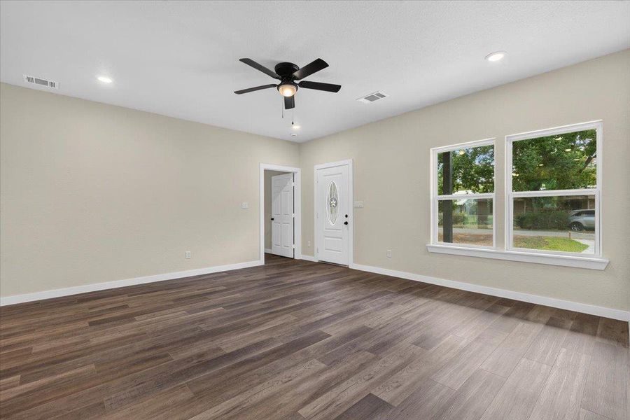 Rich wood-look flooring and recessed lighting define this versatile open living area. Rich wood-look flooring and recessed lighting define this versatile open living area.