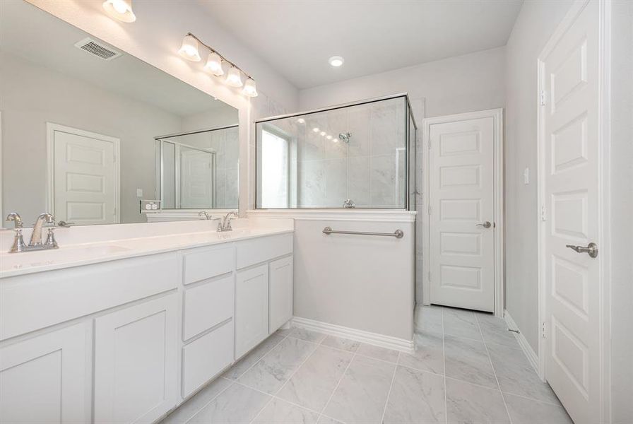 Bathroom with vanity and a shower with shower door