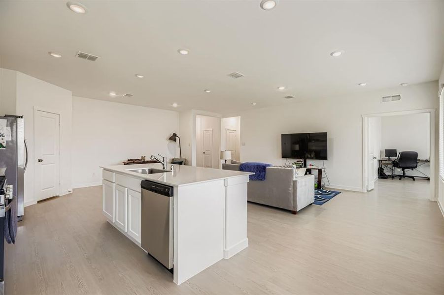 Kitchen featuring an office area, open floor plan, light wood-style flooring, stainless steel appliances, and recessed lighting