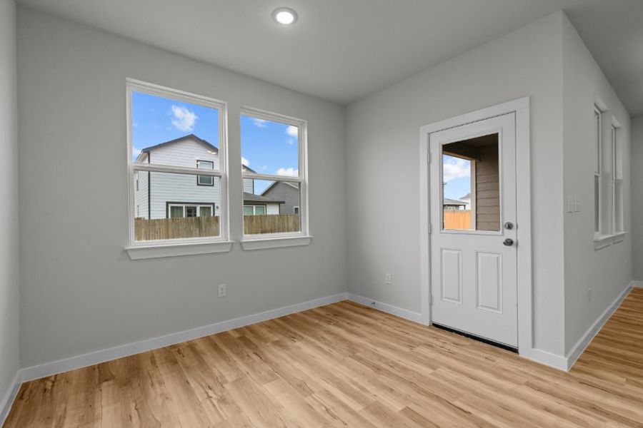 A room with a wood floor and a white door with a window. A room with a wood floor and a white door with a window.