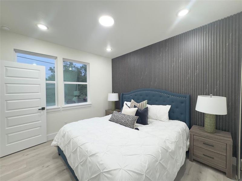 Bedroom with light hardwood / wood-style floors