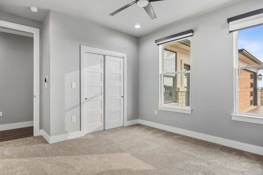 Unfurnished bedroom featuring light colored carpet, a closet, a ceiling fan, and recessed lighting