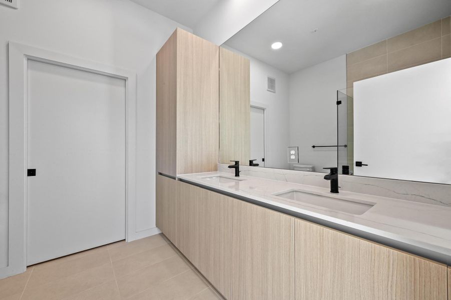 Bathroom featuring double vanity, recessed lighting, light tile patterned floors, and walk in shower Bathroom featuring double vanity, recessed lighting, light tile patterned floors, and walk in shower