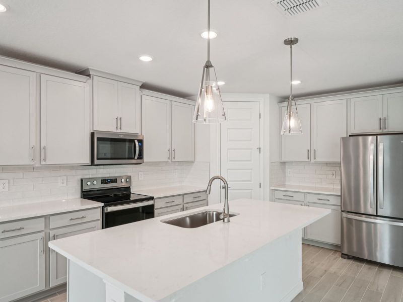 Furnished interior view inside a new home in The Grove at Stuart Crossing - Signature Series, Bartow (Image 4).