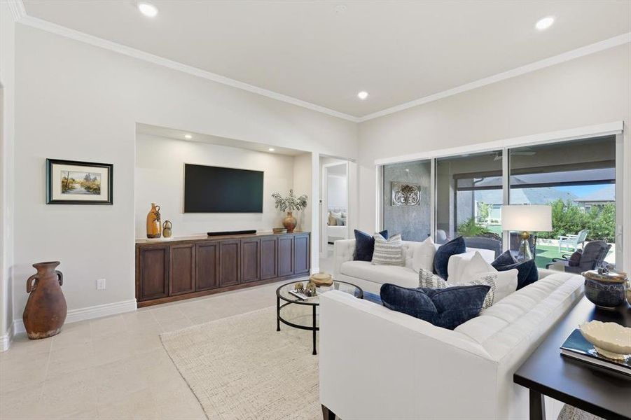 Living room with ornamental molding and recessed lighting