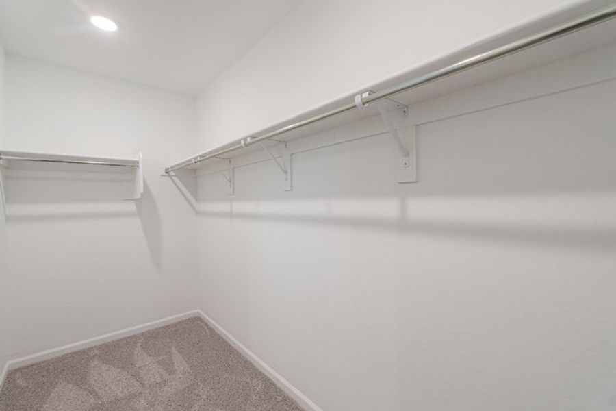 A white wall with a metal railing.