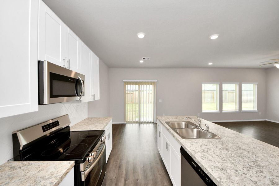 White kitchen with handles and brand new stainless steel appliances White kitchen with handles and brand new stainless steel appliances