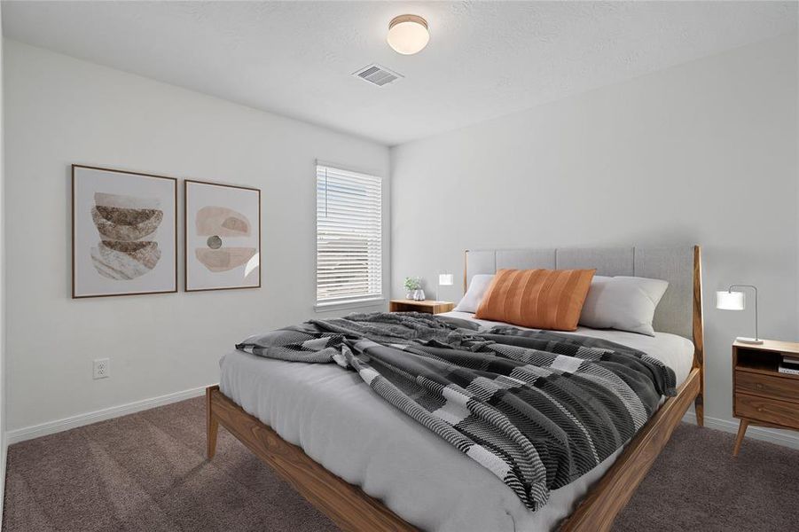 Secondary bedroom features plush carpet, custom paint and a large window.