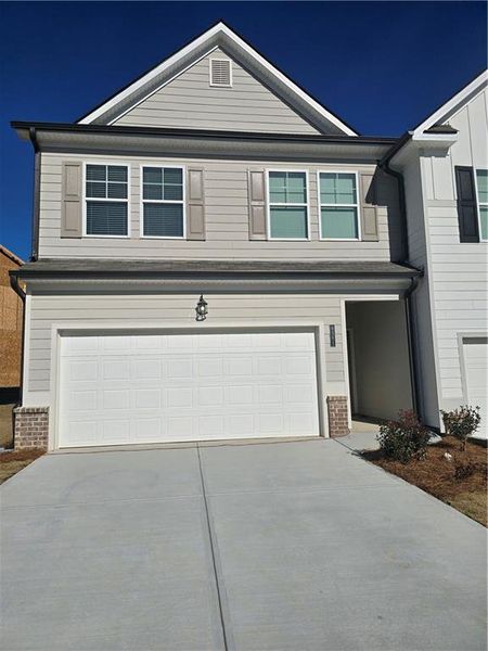 Front exterior of a new home in Sandtown Falls, South Fulton, GA, highlighting curb appeal (Image 1). Front exterior of a new home in Sandtown Falls, South Fulton, GA, highlighting curb appeal (Image 1).