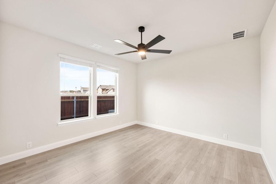 Empty room with light wood floors, white walls, ceiling fan, and double windows Empty room with light wood floors, white walls, ceiling fan, and double windows