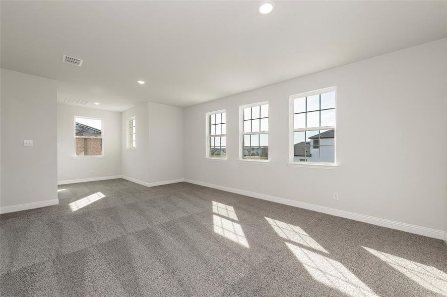 Carpeted empty room featuring recessed lighting and baseboards Carpeted empty room featuring recessed lighting and baseboards