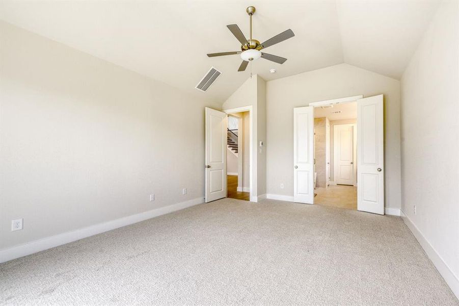 Unfurnished bedroom featuring light carpet and a ceiling fan