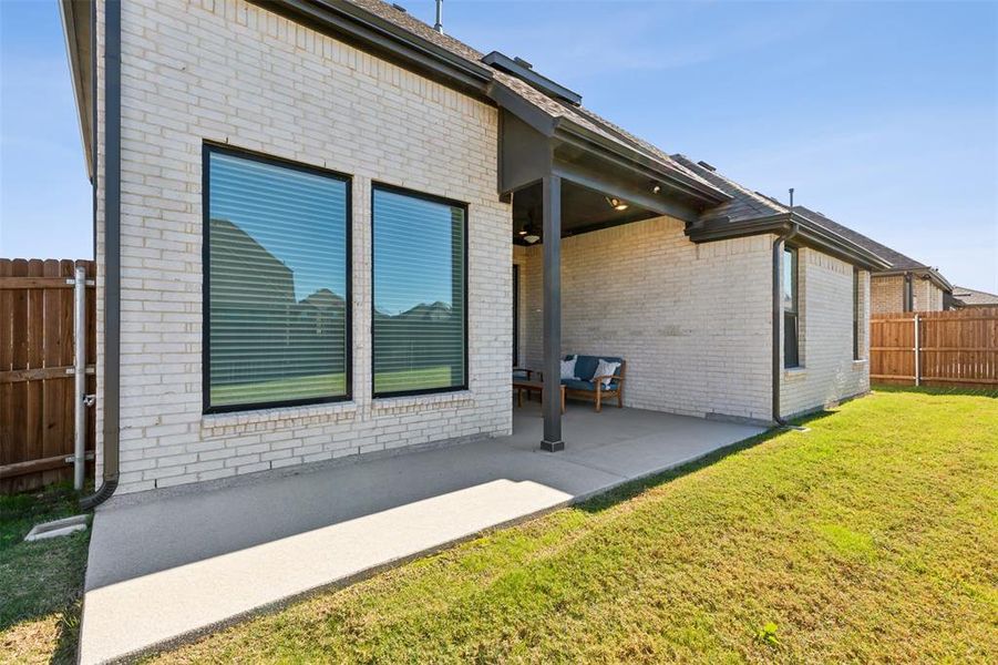 View of home's exterior with a yard and a patio area