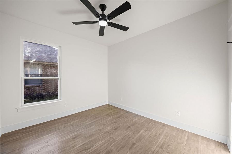 Unfurnished room featuring wood finished floors and ceiling fan