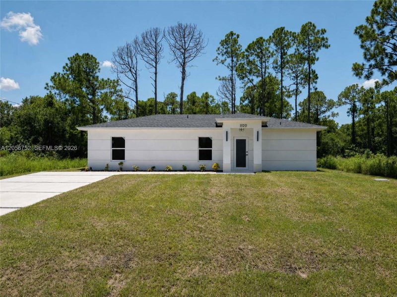 Front exterior of a new home in , Lehigh Acres, FL, highlighting curb appeal (Image 2). Front exterior of a new home in , Lehigh Acres, FL, highlighting curb appeal (Image 2).