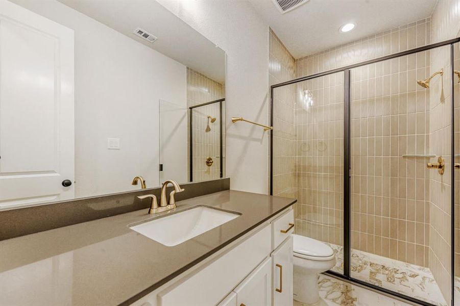 Bathroom with vanity, a stall shower, and recessed lighting