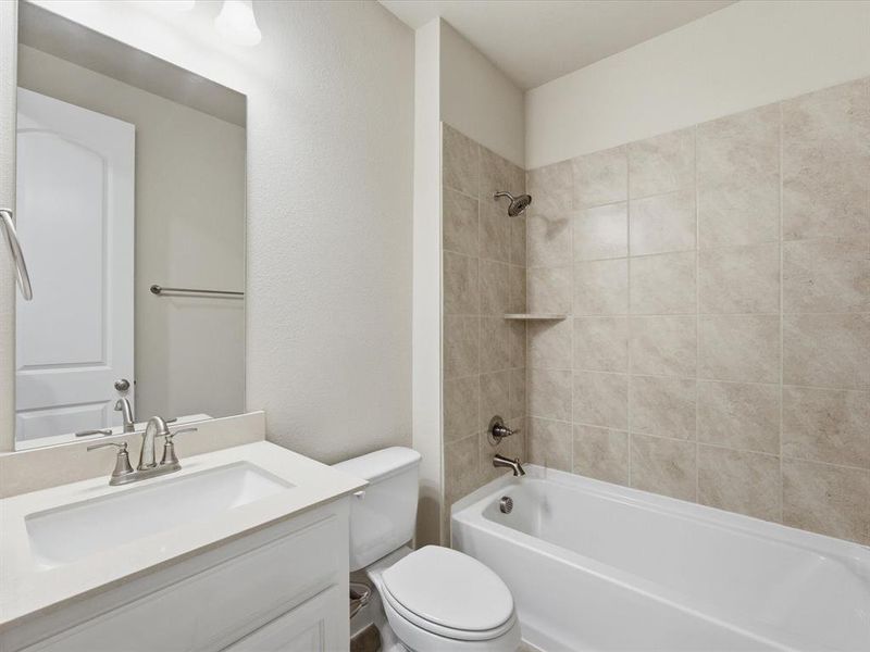 Bathroom featuring a white vanity with an undermount sink, brushed nickel faucet, and a large mirror