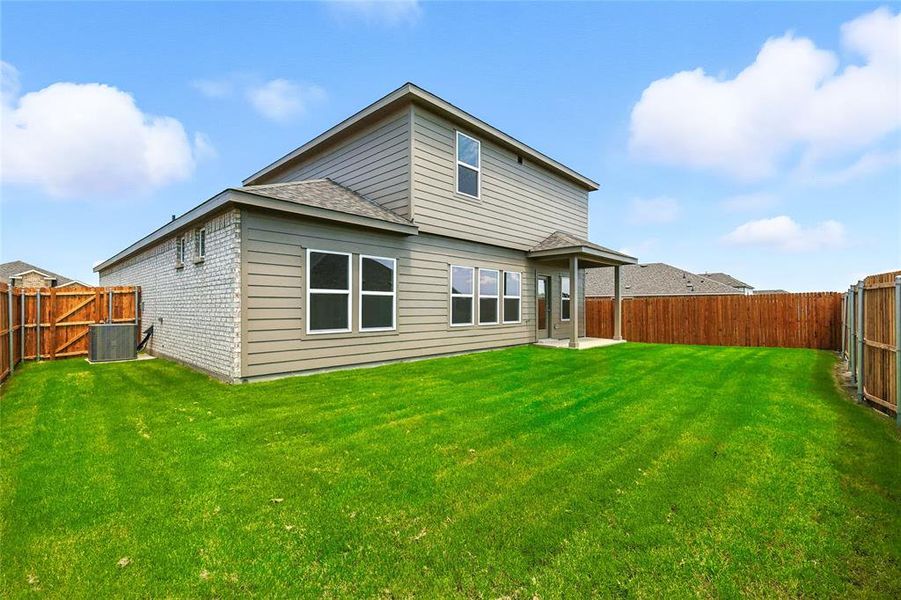 Back of house with a patio, a fenced backyard, brick siding, and roof with shingles Back of house with a patio, a fenced backyard, brick siding, and roof with shingles
