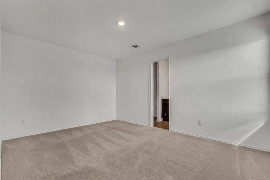 Plush carpeting and recessed lighting create a comfortable environment in this bedroom. Plush carpeting and recessed lighting create a comfortable environment in this bedroom.