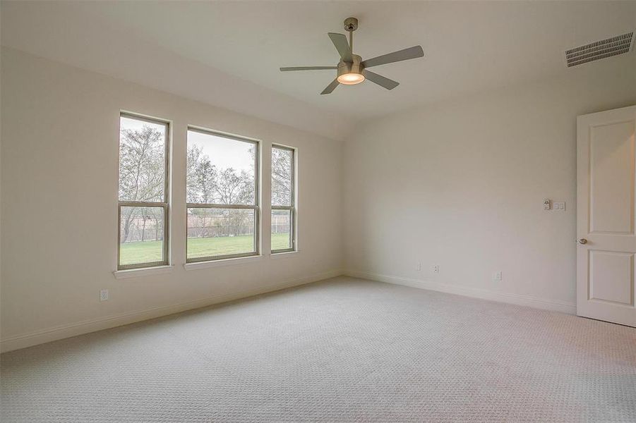 Spare room with light colored carpet and ceiling fan