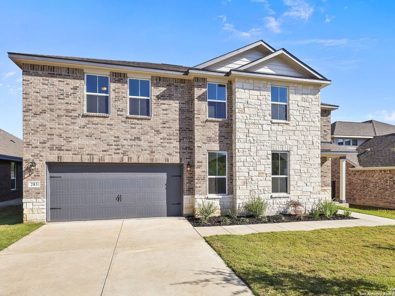 Front exterior of a new home in The Reserve at Potranco Oaks, Castroville, TX, highlighting curb appeal (Image 2).