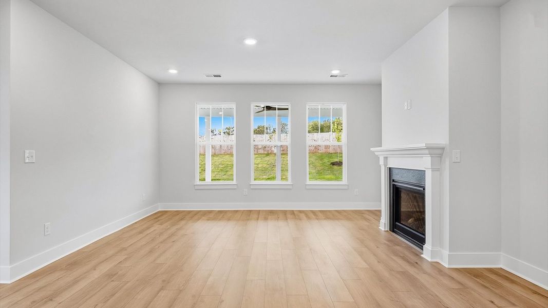 Memorable moments begin in this elegant, open family room with hardwood flooring and refined finishes in Piedmont, SC