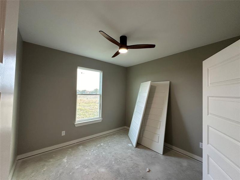 Unfurnished bedroom featuring ceiling fan