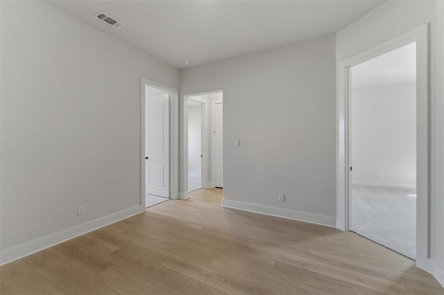 Unfurnished bedroom featuring light wood-style flooring and baseboards Unfurnished bedroom featuring light wood-style flooring and baseboards