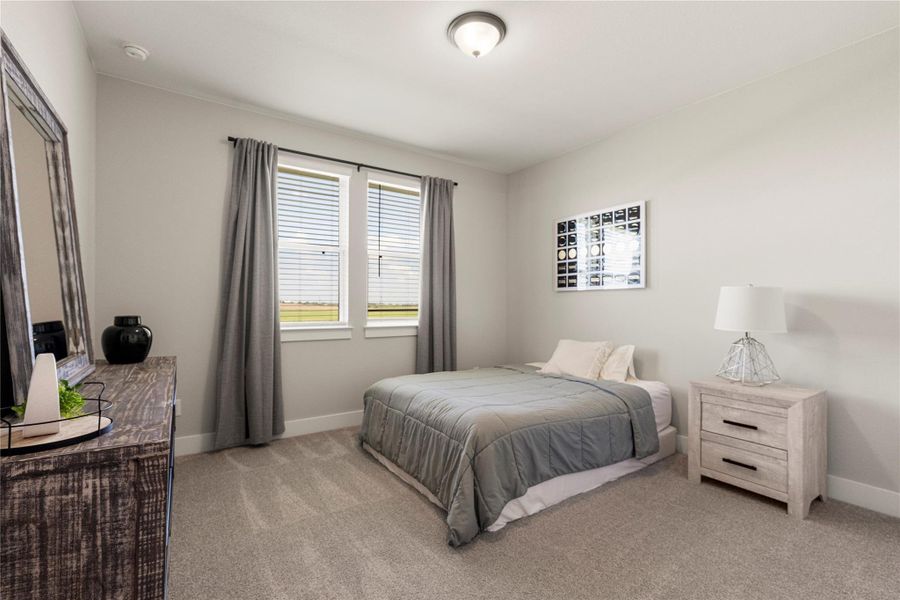 Plush carpeting and natural light create a serene and inviting bedroom space. Plush carpeting and natural light create a serene and inviting bedroom space.